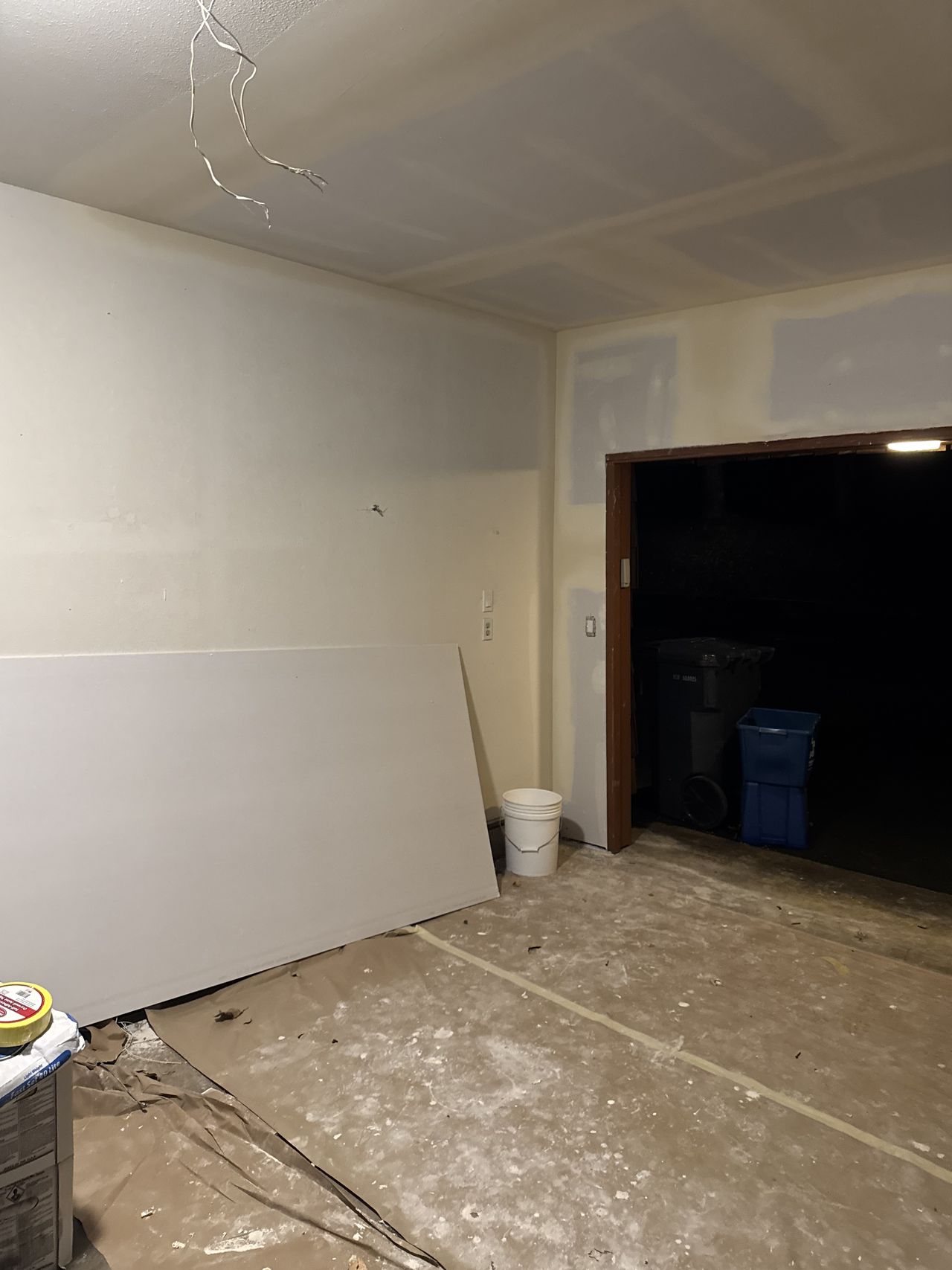The same garage with new drywall on the walls and ceiling