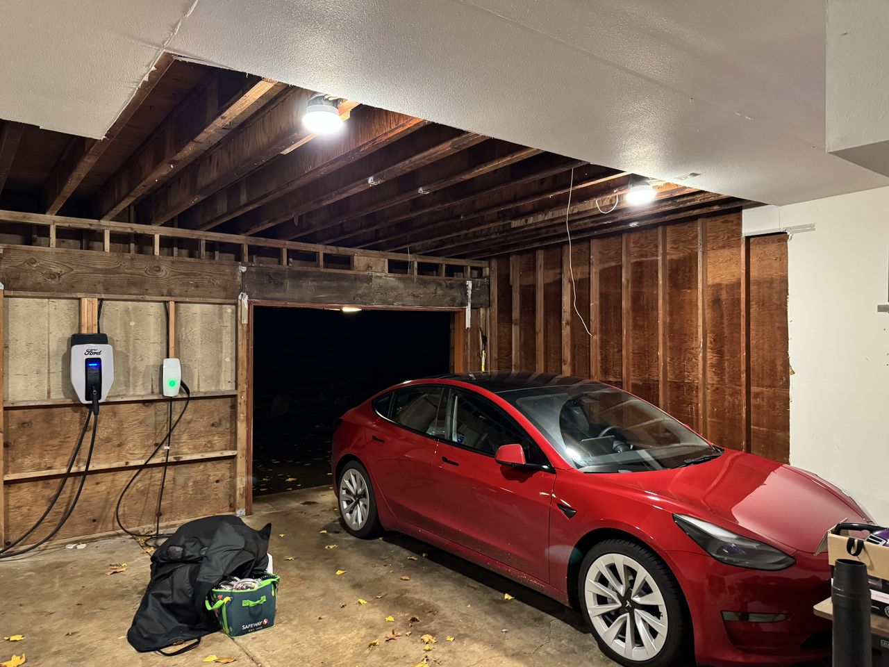 Garage with open joists and bare framing before drywall