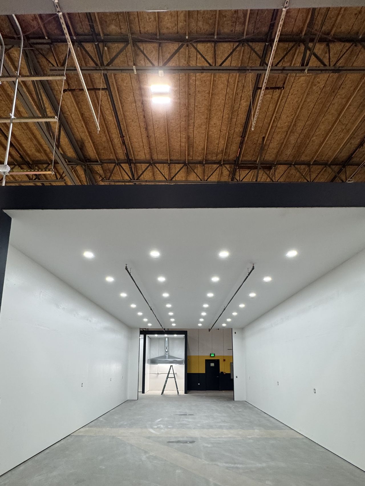 The same corridor with walls hung, finished, and painted white