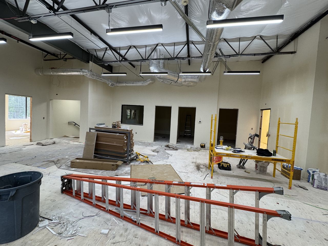 Open commercial office with new drywall finished around the windows and doors
