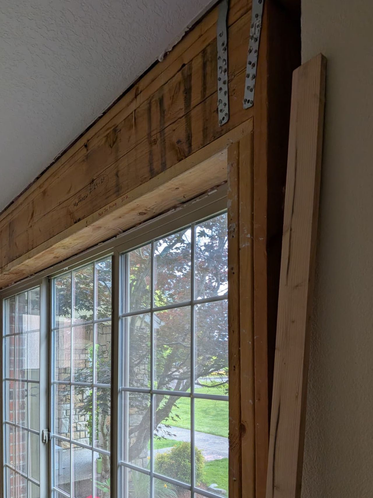 Wall above a wide window opened up to the header and framing