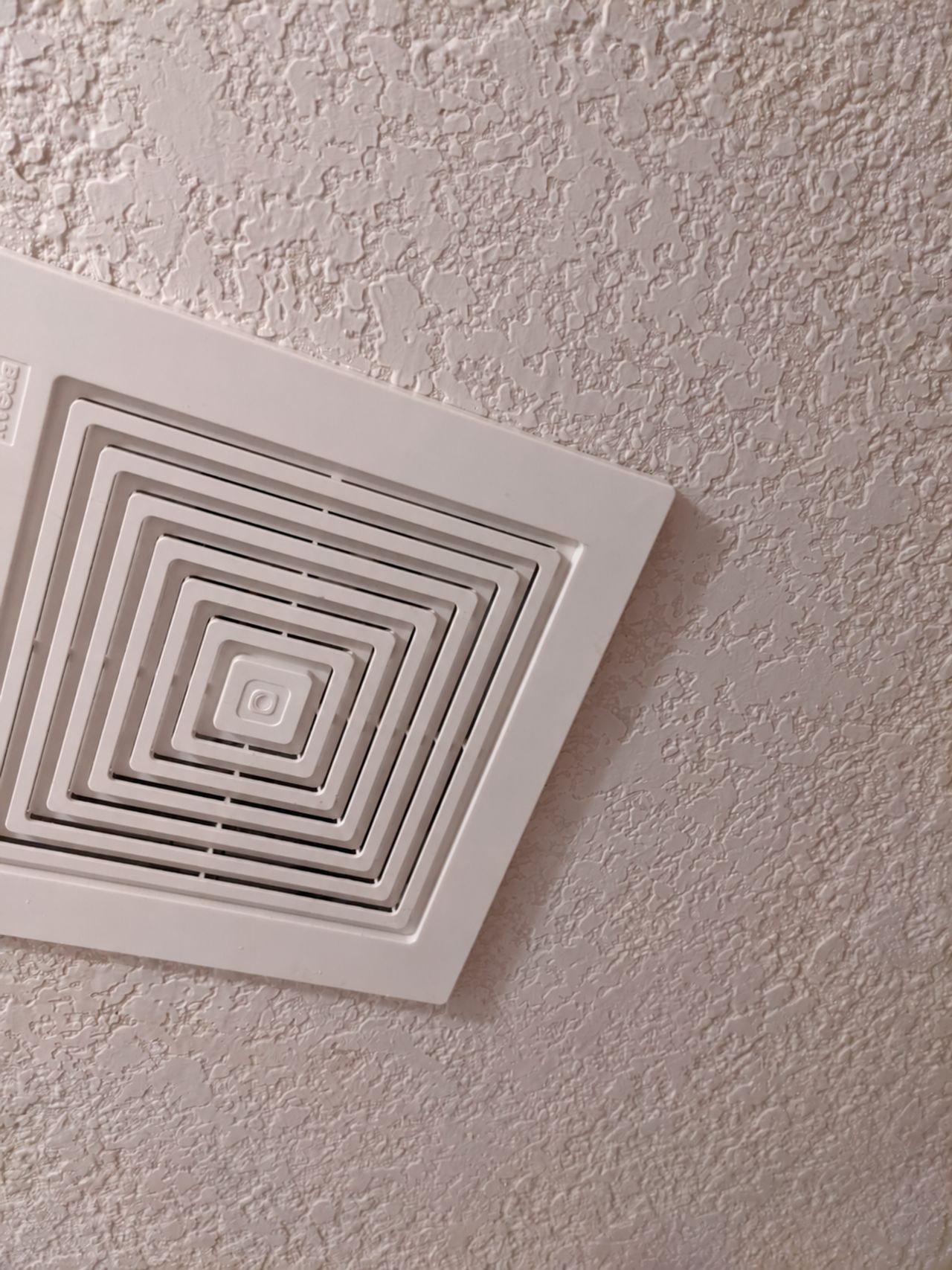 The ceiling around the vent retextured and painted, with no stain left